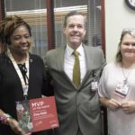 Chancellor Cam Patterson, M.D., MBA and Amber Daugherty, information technology manager, congratulate Zina Kidd (left) on being the UAMS MVP of the Month. Kidd works in the Appointment Business Center.