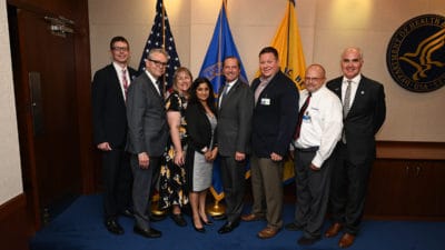 Curtis Lowery, M.D., second from left, stops for a photo with Secretary of Health and Human Services Alex M. Azar, fifth from left, during a break in the secretary's Roundtable with Rural Health Innovators. Lowery gave a presentation at the roundtable along with representatives from programs in other states who are showen here with Lowery and Azar.