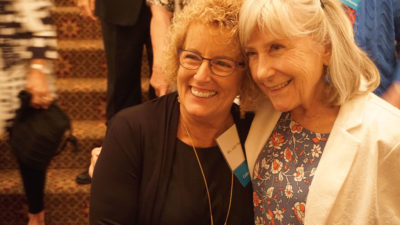 Judy Huneycutt and Jill Lancaster, both CON '69, pose for photos during the Saturday night Golden Grad dinner at the Capital Hotel.