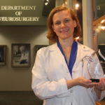 Dr. Petersen holding award