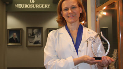 Dr. Petersen holding award