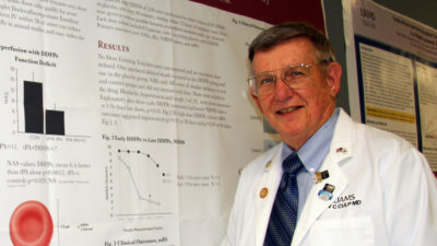 Portrait of Dr. Culp near research poster