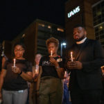 UAMS faculty, staff and students hold lighted candles in memory of Edith Irby Jones, M.D., who died July 15.