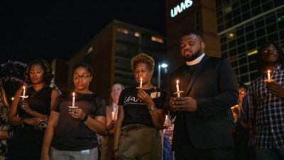 UAMS faculty, staff and students hold lighted candles in memory of Edith Irby Jones, M.D., who died July 15.