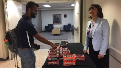 Medical student Dhruba Dasgupta receives a Kind bar from Stephanie Gardner, Senior Vice Chancellor for Academic Affairs & Provost, during Kindness Week.