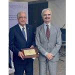 Drs. Mehta and Bolli standing together with plaque