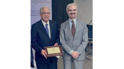 Drs. Mehta and Bolli standing together with plaque