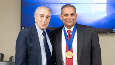 Ernest Ferris, M.D., longtime chair of the Department of Radiology and the chair's namesake, and Arabinda K. Choudhary, M.D., wearing the commemorative medallion.