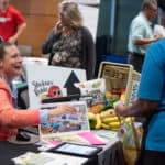 Mande Corbett tells fair attendees about the Stocked & Reddie food pantry.