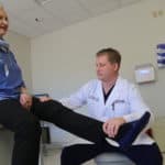 Paul Edwards, M.D., with total hip replacement patient Joan Baldridge.