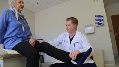 Paul Edwards, M.D., with total hip replacement patient Joan Baldridge.