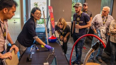 UAMS’ Thidathip (Tip) Wongsurawat, Ph.D., demonstrates use of a hand-held DNA sequencing device.