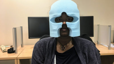 Devin Guillory of the UAMS Brain Imaging Research Center wears a head mold created from 3-D photos of her.