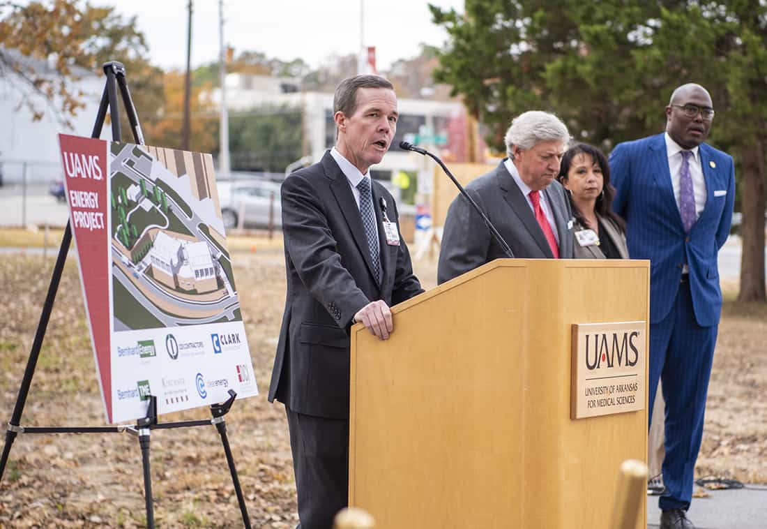 UAMS Chancellor Cam Patterson, left, speaks at the start of the groundbreaking ceremony for a $150 million energy project as UA Board of Trustees Chair John Goodson, Christina Clark, UAMS chief operating officer and Little Rock Mayor Frank Scott Jr. wait to address attendees.