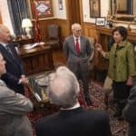 Teresita Bellido, UAMS' newest ARA Scholar, second from right, talks to UAMS Chancellor Cam Patterson, left and Gov. Asa Hutchinson, second from left and other dignitaries before the formal ceremony recognizing her as an ARA Scholar.