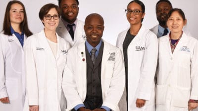 Antino Allen, seated center, leads one section of the College of Pharmacy's graduate program. Some of his students, left to right, are Madison Trujillo, Taylor McElroy, Tauren Brown, Pilar Simmons and Fabio Ntagwabira. Lab technician and research associate Jing Wang, M.D., Ph.D., is a research associate on Allen's research team.