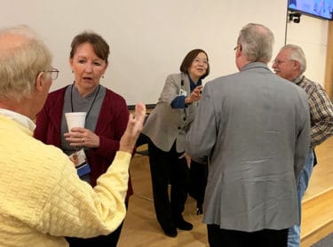 During a break between sessions, Denise Compton, second from left, and Jeanne Wei, third from left, answer questions from attendees at the Dementia Update.