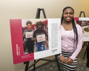 Kaniya Lawson with her PhotoVoice poster. 