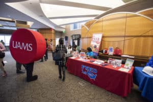 UAMS mascot Reddie visits the volunteer fair, where attendees could sign up to volunteer with local nonprofit and civic organizations.