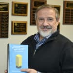 Edgar Garcia-Rill holds a copy of the recently published "Fundamentals of Neuroscience and the Law," which he co-authored with the late Erica Beecher-Monas.