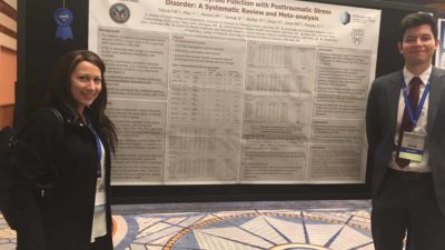 Researchers near science poster