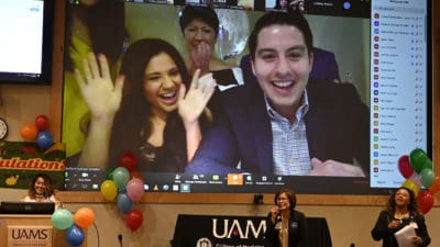 Students on screen with Dr. Tariq in foreground