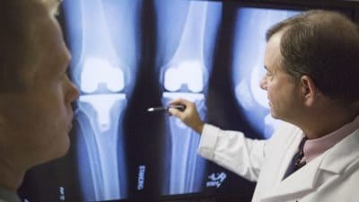 C. Lowry Barnes, M.D., chairman of the Department of Orthopaedic Surgery, examines an x-ray.