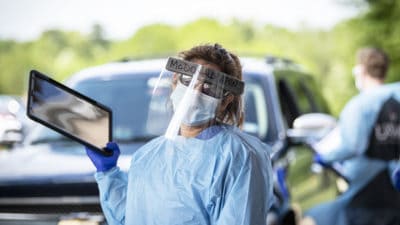 Barbara McDonald, APRN, pauses for a moment between patients during drive-through COVID-19 evaluations April 9 in Texarkana.
