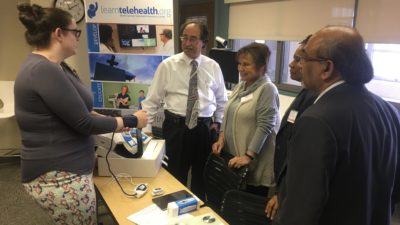 Digital health staff doing smart phone app demonstration