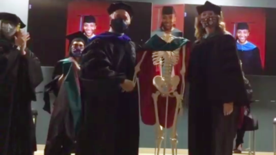 The College of Health Professions Physical Therapy program used skeletons as stand ins for the students in their hooding ceremony.