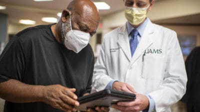 Dr. Bumpass helping patient with form