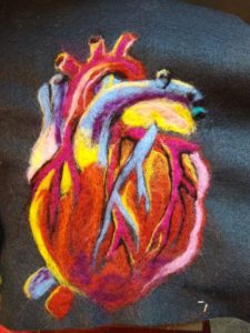 Jennifer Steck submitted two very different pieces for this year's exhibit. One was a portrait of Albert Einstein, while the other, "Painting with Wool," used needle felting to create a human heart.