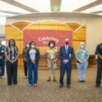 Chancellor Cam Patterson, M.D., MBA, center, stops for a photo with nine of the 12 MVP award winners celebrated July 10 at a noon luncheon.