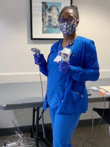 Stacy Thurston, a dental assistant in the UAMS Delta Dental of Arkansas Foundation Oral Health Clinic, volunteers at an employee and visitor screening entrance. Staff from the dental clinic were in charge of the screening at the entrance closest to Doc Java.