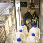 Calvin Tunstall picks up a gallon of milk at Stocked & Reddie. The food pantry celebrated its first birthday in July.