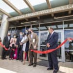 Dr. Patterson cutting clinic ribbon