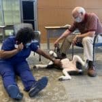 Kewanna Gibbons scratches Lucy's belly during pet therapy Sept. 9.