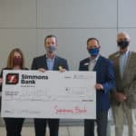 UAMS Chancellor Cam Patterson, M.D., MBA, holds the $25,000 check with Amy Wenger, M.H.S.A., vice chancellor for Regional Campuses and Robert "Rob" Robinson, community president for Simmons Bank El Dorado. To their right is Freddie Black, chief business development officer for Simmons Bank.