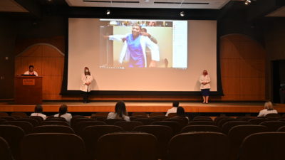 Nursing students donned their white coats from remote locations while faculty applauded their transition to clinical care from the Little Rock campus.