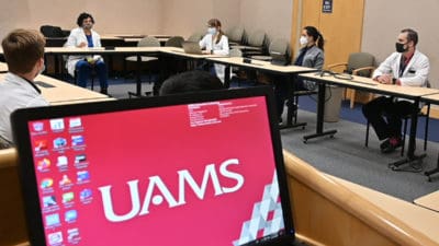 Priya Mendiratta, M.D., second from left, talks to UAMS students, residents and fellows about the new Geriatric Buddy program.