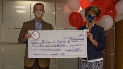 Chancellor Patterson presents Molly Gathright, M.D. with the $30,000 grant for the UAMS College of Medicine Office of Graduate Medical Education. UAMS has set a goal to increase residency positions in Arkansas by 200 slots over the next 10 years, with at least 50% of those spots in primary care.