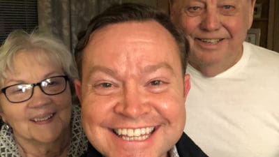 Flanked by his mother and father, Grady O. Brown, center, takes a family photo in early 2020 before the COVID-19 pandemic in the U.S. He supports his mother, Virginia, in caring for his father, who also is named Grady Brown.