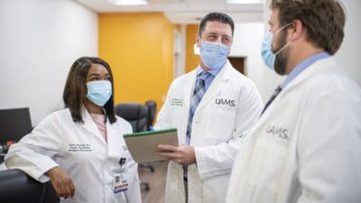 UAMS family medicine residents stop for brief conversation in a hallway at the UAMS Family Medical Center in Batesville.