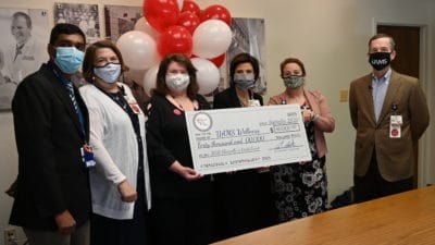 Chancellor Patterson, at right, presents the wellness team with the $40,000 grant. From right to left are Natalie Cannady, M.Ed., chief wellness officer; Trenda Ray, Ph.D., RN, chief nursing officer; Diane Jarrett, Ed.D., assistant program director for the College of Medicine Graduate Medical Education enterprise; Elizabeth Schmit, Ph.D., assistant professor in the College of Medicine Department of Family & Preventive Medicine; and Shashank Kraleti, M.D., residency program director for the Department of Family & Preventive Medicine.