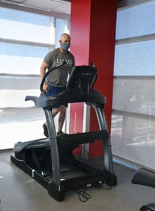 Adam Carter exercises on the new True Fitness Alpine Runner, which is capable of speeds up to 12 mph and incline variations from negative 3% to a 30% incline.