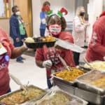 Nutrition Services employees serve the holiday meal on Dec. 10. “Nutrition Services employees have the hardest job each year with putting on this celebration, and they all do it with smiles on their faces and absolutely wonderful attitudes,” said organizer Annabeth Johnson.