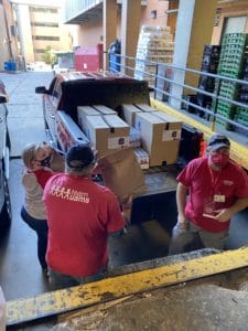 Volunteers load vehicles making off-campus food deliveries on Dec. 9.