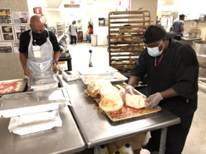 Workers in the UAMS Cafeteria slice turkey for the celebration. More than 10,500 turkey slices were served during the week's festivities.