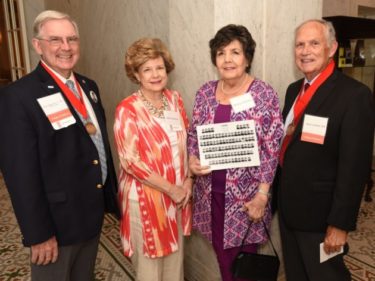 Jack Blackshear, M.D., and his wife, Bobbie, visit with Becky Lockhart (holding yearbook photo composite) and 1968 alumnus David Lockhart, M.D., during Alumni Weekend 2018. The physicians are wearing medallions commemorating their “Golden Graduate” 50-year reunion.