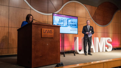 Chancellor Cam Patterson, right, listens as Sharanda Williams, chair of the House of Delegates, introduces him Feb. 23 at the State of the University presentation.